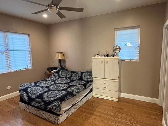 bedroom with ceiling fan and hardwood / wood-style floors