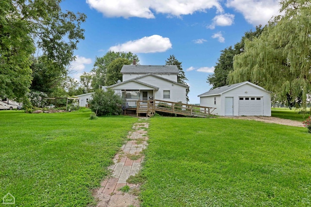 view of front of house with driveway, an outdoor structure, a detached garage, a wooden deck, and a front lawn