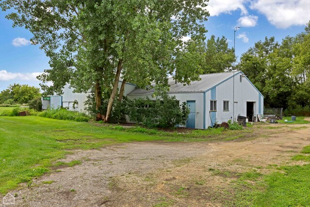 view of side of property with an outbuilding