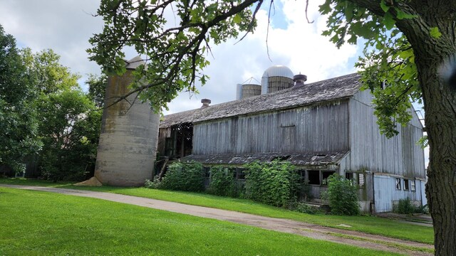 view of property exterior featuring a lawn