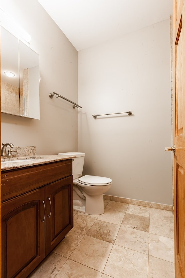 bathroom featuring vanity, toilet, and tile patterned flooring