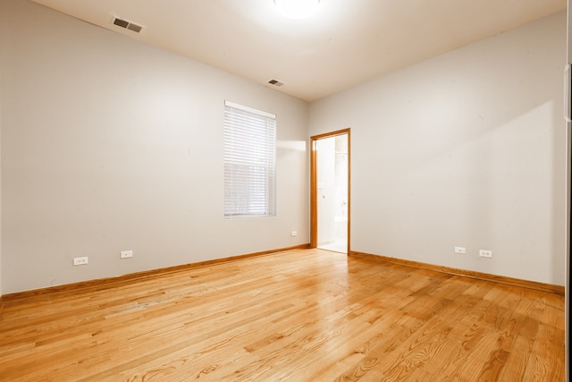 spare room with light hardwood / wood-style flooring