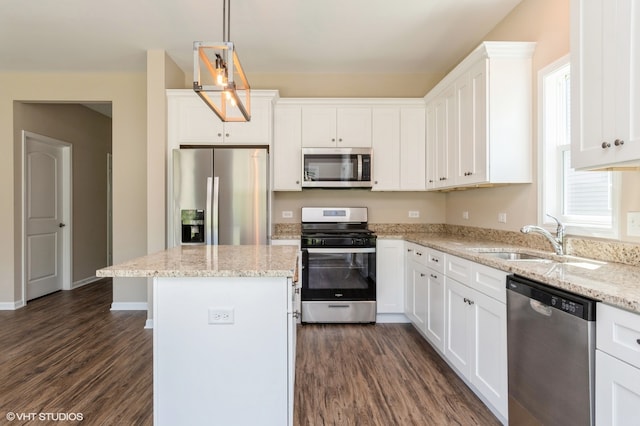 kitchen featuring white cabinetry, a kitchen island, stainless steel appliances, decorative light fixtures, and dark hardwood / wood-style flooring