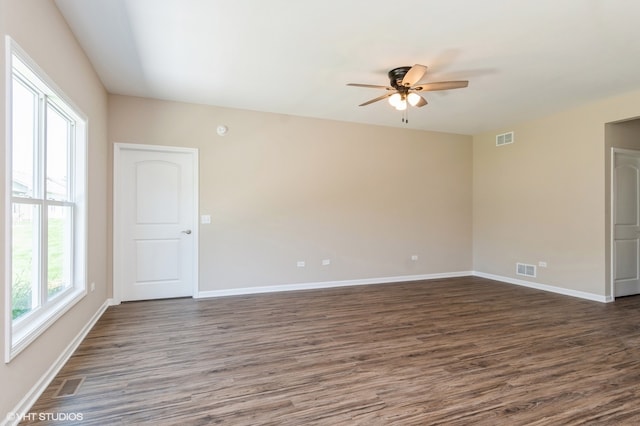 unfurnished room with ceiling fan and dark wood-type flooring