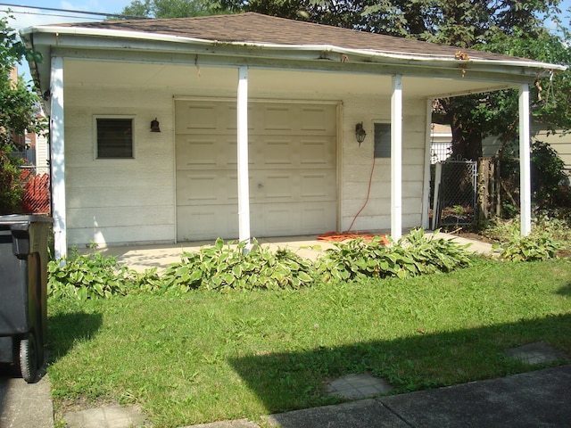 view of outdoor structure featuring a carport and a yard