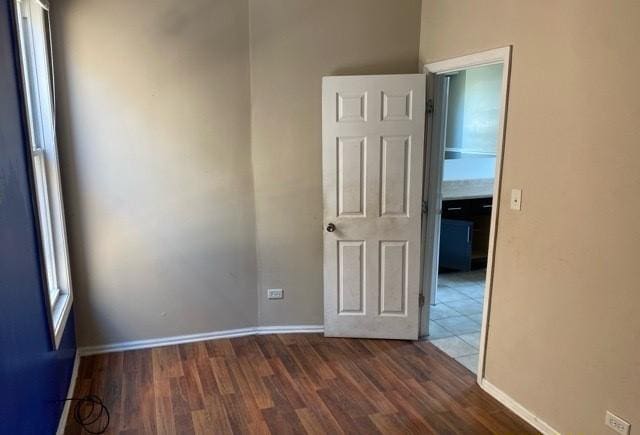 unfurnished room with dark hardwood / wood-style floors