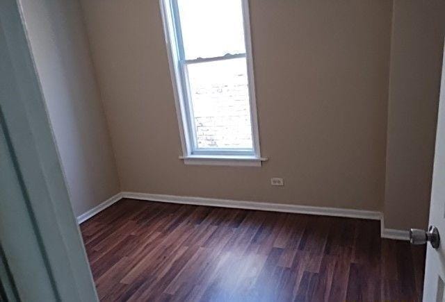 spare room featuring dark hardwood / wood-style floors