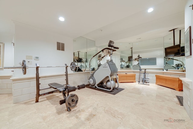 workout area featuring visible vents, recessed lighting, and ornamental molding