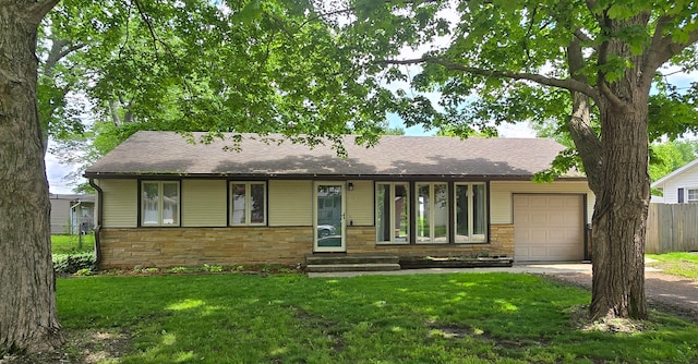 ranch-style house with a garage and a front yard