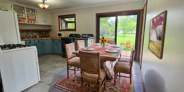 dining area with washer and clothes dryer and light tile patterned floors