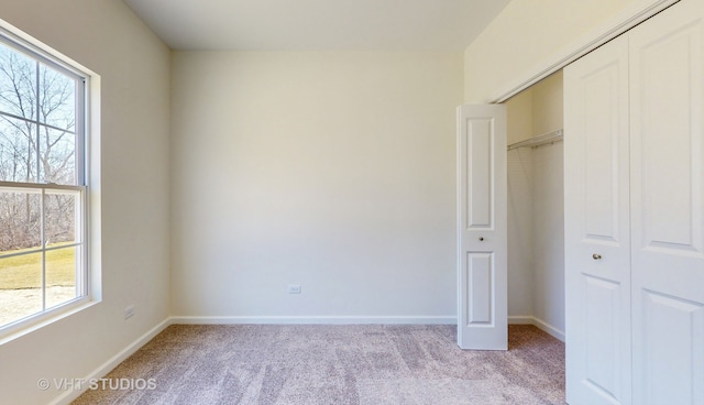 unfurnished bedroom with light carpet