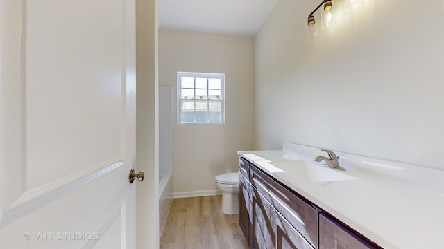 full bathroom with vanity, toilet, hardwood / wood-style flooring, and bathtub / shower combination