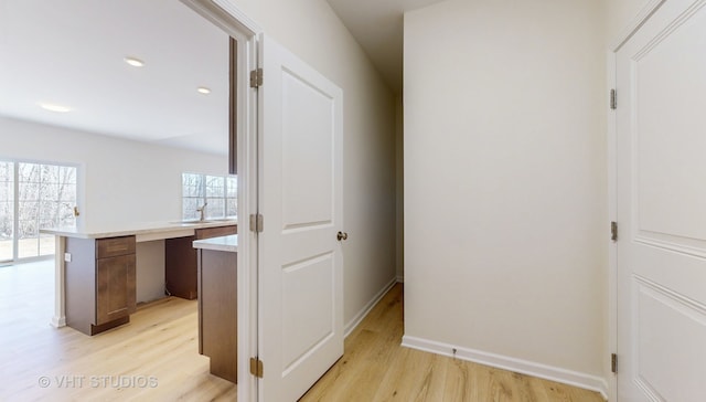 hallway featuring light hardwood / wood-style flooring and sink