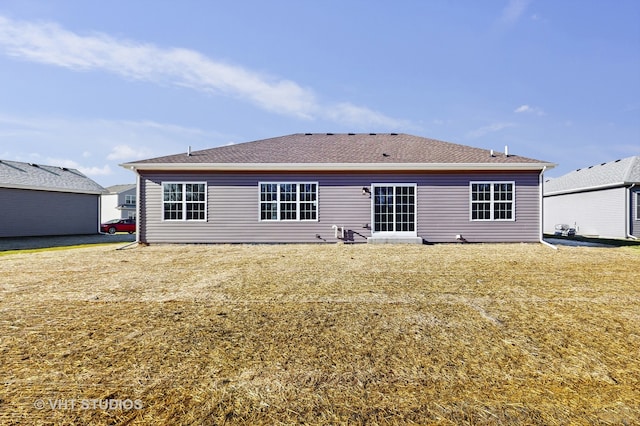 rear view of house featuring a lawn