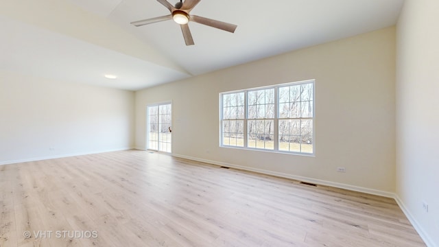 spare room featuring light hardwood / wood-style flooring, lofted ceiling, and ceiling fan