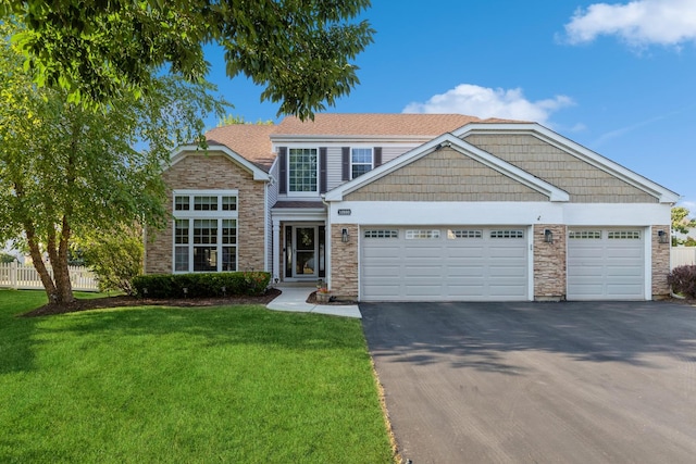 view of front facade with driveway, a garage, stone siding, fence, and a front lawn