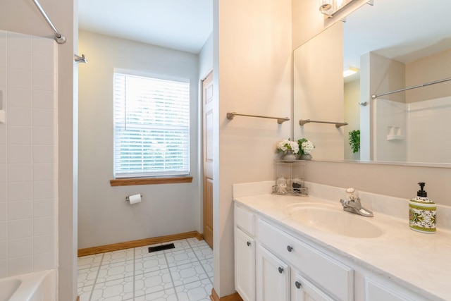 full bathroom featuring washtub / shower combination, vanity, visible vents, and baseboards