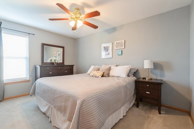 bedroom with a ceiling fan, carpet, and baseboards