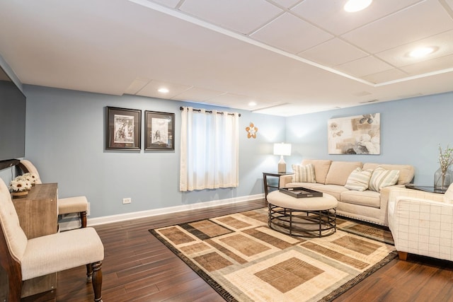 living room with a paneled ceiling, baseboards, dark wood-type flooring, and recessed lighting