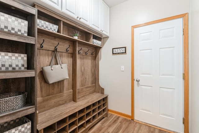 mudroom featuring baseboards and light wood finished floors