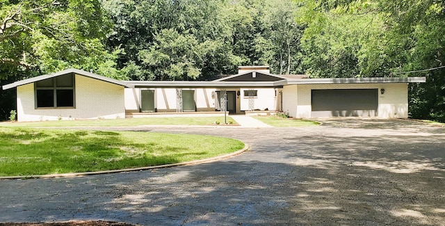 view of front of house with a front lawn and a garage