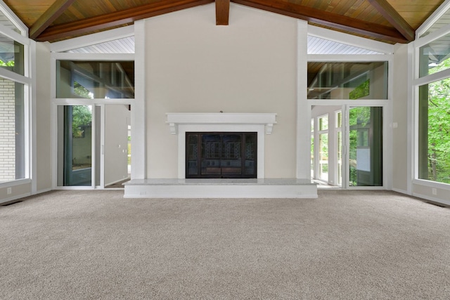 unfurnished living room featuring carpet flooring and plenty of natural light