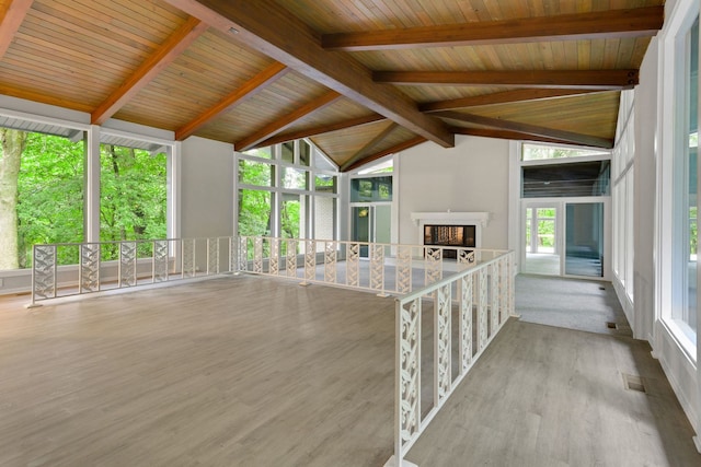 unfurnished sunroom featuring wood ceiling and lofted ceiling with beams