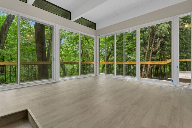 unfurnished sunroom with beamed ceiling and wooden ceiling