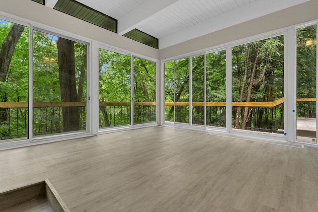 unfurnished sunroom with beamed ceiling