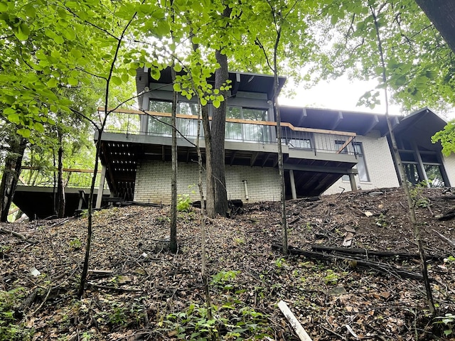 rear view of property featuring a wooden deck