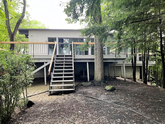 back of house featuring a wooden deck