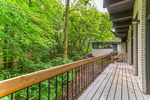 wooden deck featuring a sunroom