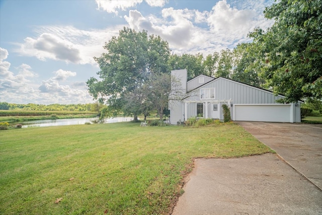 view of front facade with a water view, a front lawn, and a garage