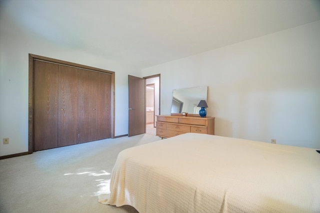 bedroom with light colored carpet and a closet