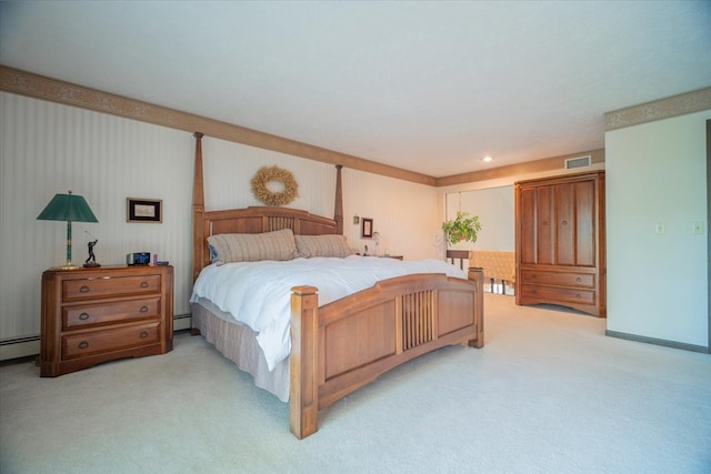 bedroom with light carpet and a baseboard heating unit