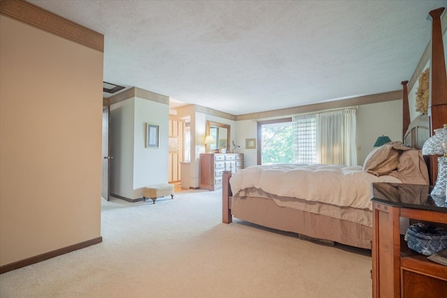 bedroom featuring a textured ceiling and light carpet