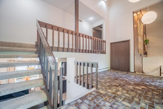 staircase featuring a baseboard radiator