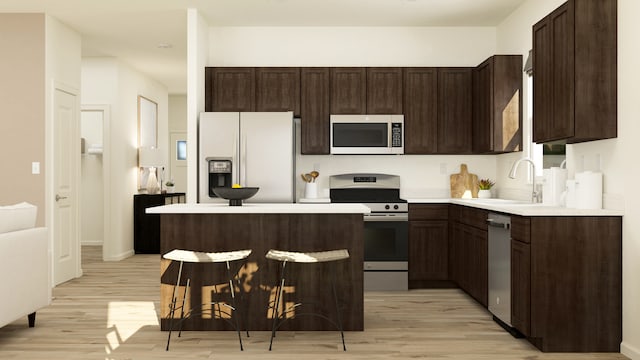 kitchen featuring dark brown cabinetry, sink, light wood-type flooring, and stainless steel appliances