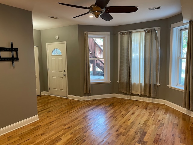 foyer entrance featuring light hardwood / wood-style floors, a healthy amount of sunlight, and ceiling fan