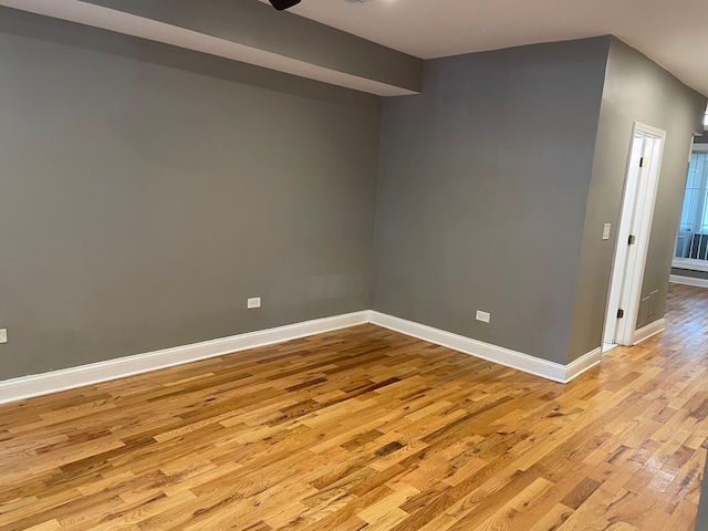 empty room with light hardwood / wood-style flooring