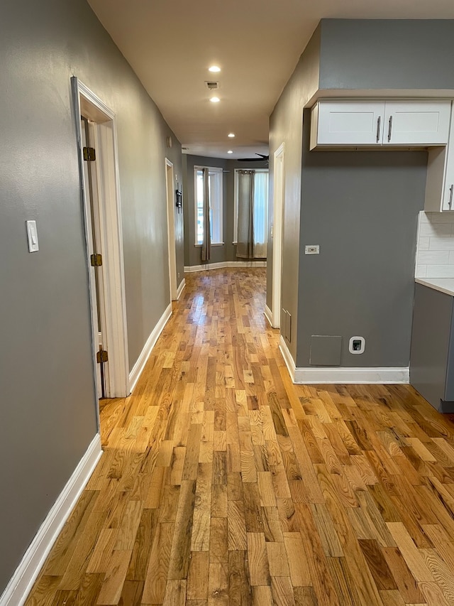 hallway with light hardwood / wood-style flooring