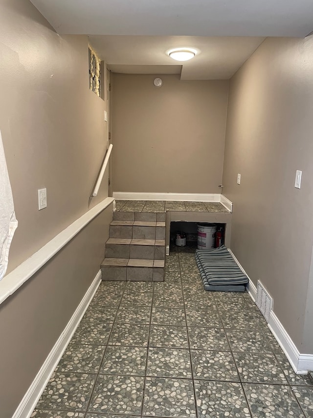 clothes washing area with dark tile patterned floors