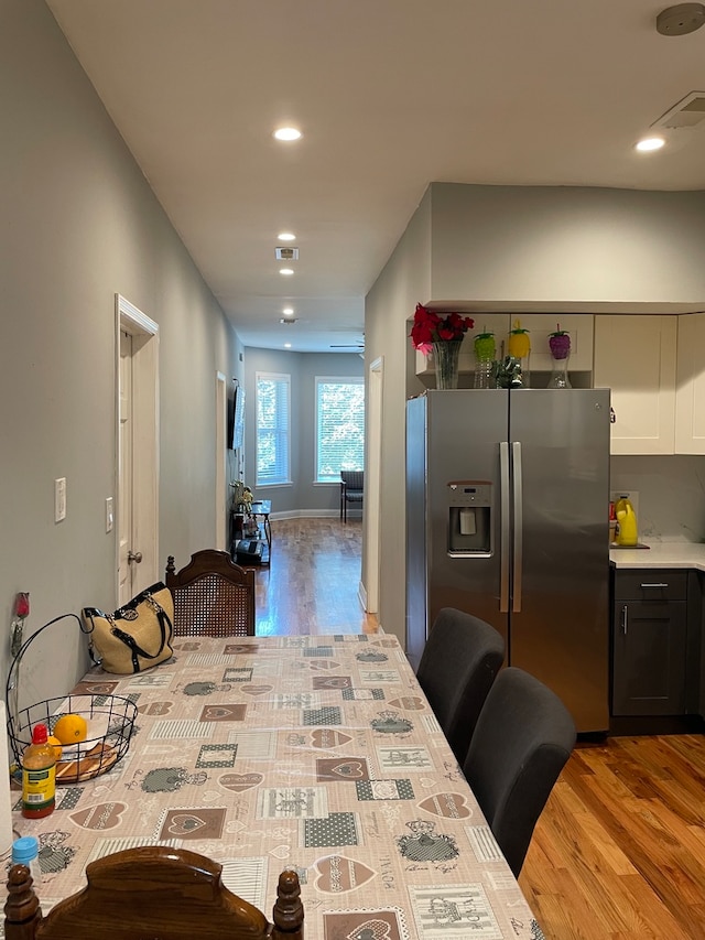 kitchen with light hardwood / wood-style floors and stainless steel fridge