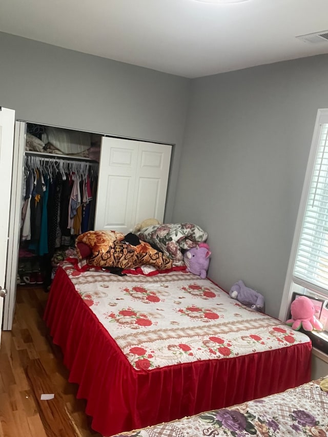 bedroom with a closet and dark hardwood / wood-style flooring