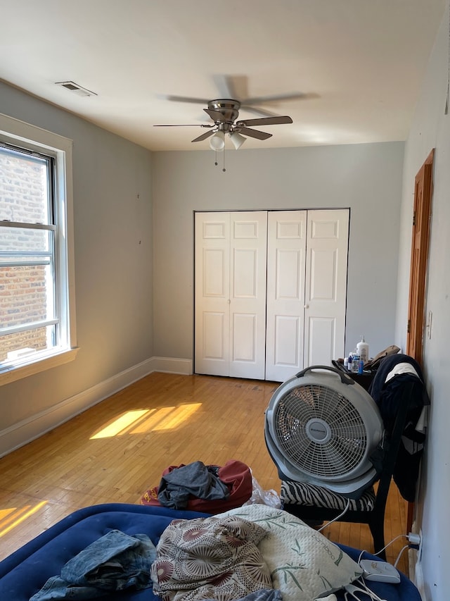 bedroom with hardwood / wood-style floors and ceiling fan