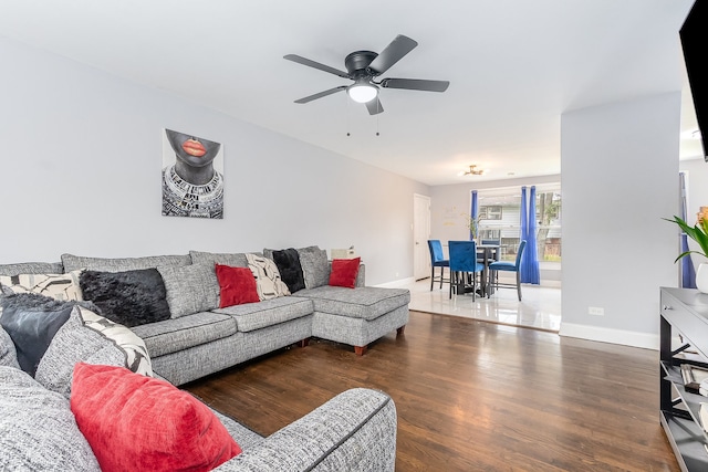 living room featuring hardwood / wood-style floors and ceiling fan