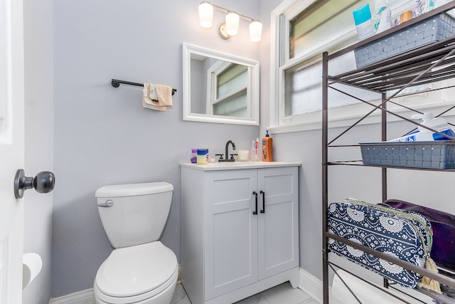 bathroom with vanity, tile patterned flooring, and toilet