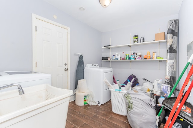 laundry room with washer and dryer, dark hardwood / wood-style flooring, and sink