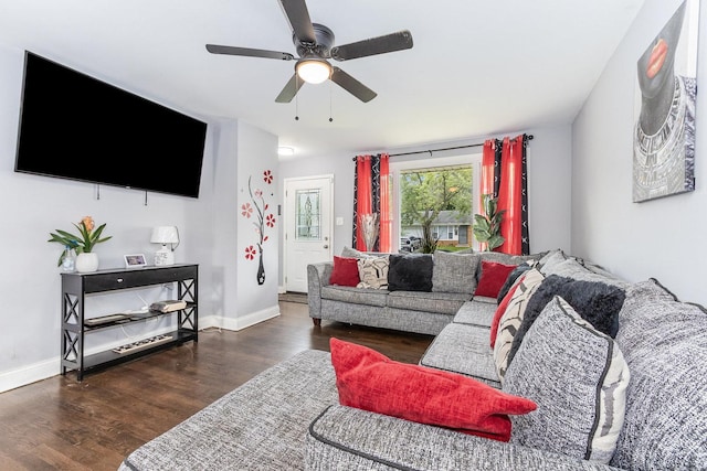 living area with a ceiling fan, wood finished floors, and baseboards