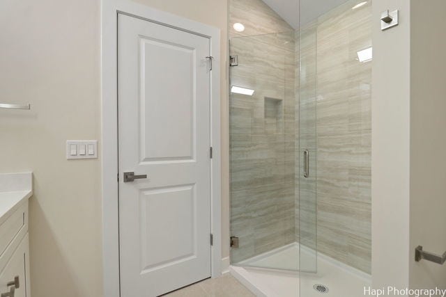 bathroom with vanity and a shower with shower door